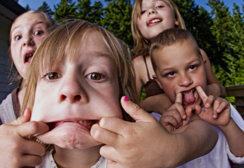 Four kids pulling silly faces at the camera