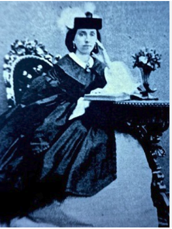 Lady Jane Wilde seated at a writing desk, in an old portrait